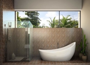 A bathroom with a large tub and glass shower door.