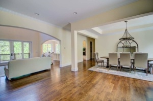 A living room with hard wood floors and white walls.