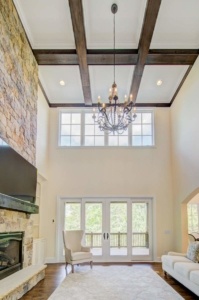 A chandelier hangs above the fireplace in this large room.