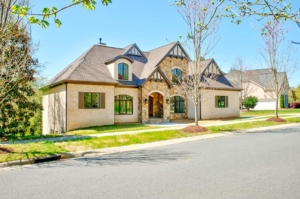 A large house with a tree in front of it.