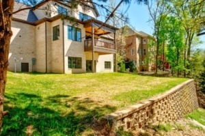 A large house with a brick wall in the foreground.