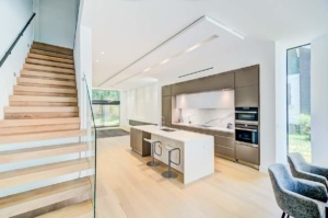 A kitchen with stairs and a large island
