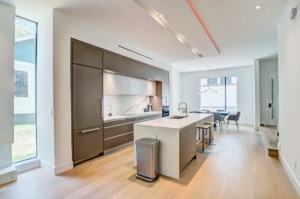 A kitchen with an island and wooden floors
