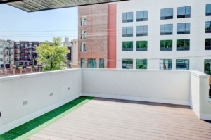 A large open deck with green grass on the ground.