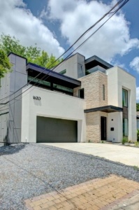 A large white house with a garage in the front.