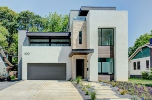A modern home with a garage door and driveway.