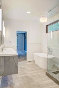 A bathroom with two sinks and a large mirror.