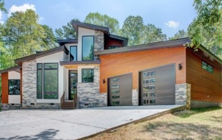 A house with two garage doors and a driveway.