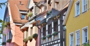 A row of houses with flower boxes on the windows.