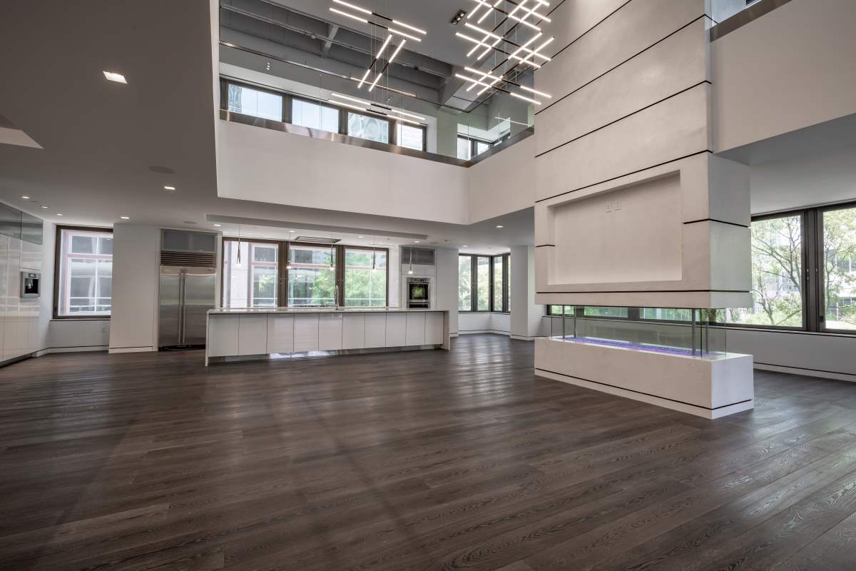 A large room with wooden floors and white walls.