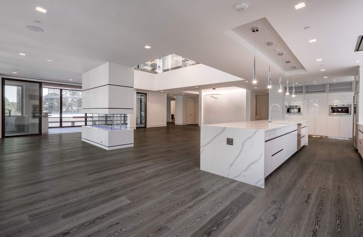 A large room with white walls and wooden floors.