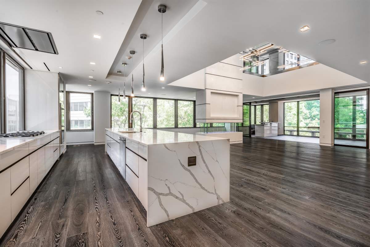 A large open kitchen with marble counter tops.