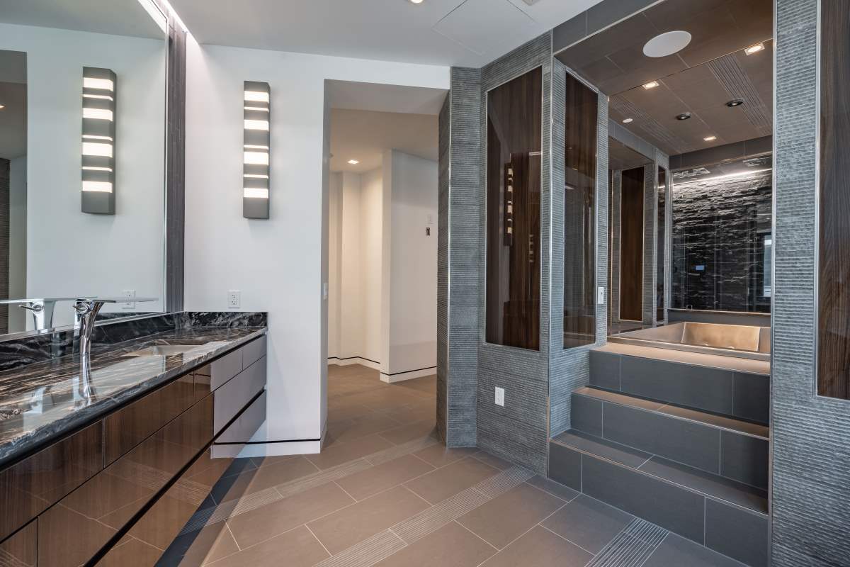 A bathroom with tiled floors and walls.