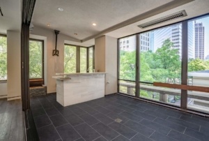 A room with large windows and a bar in the center.