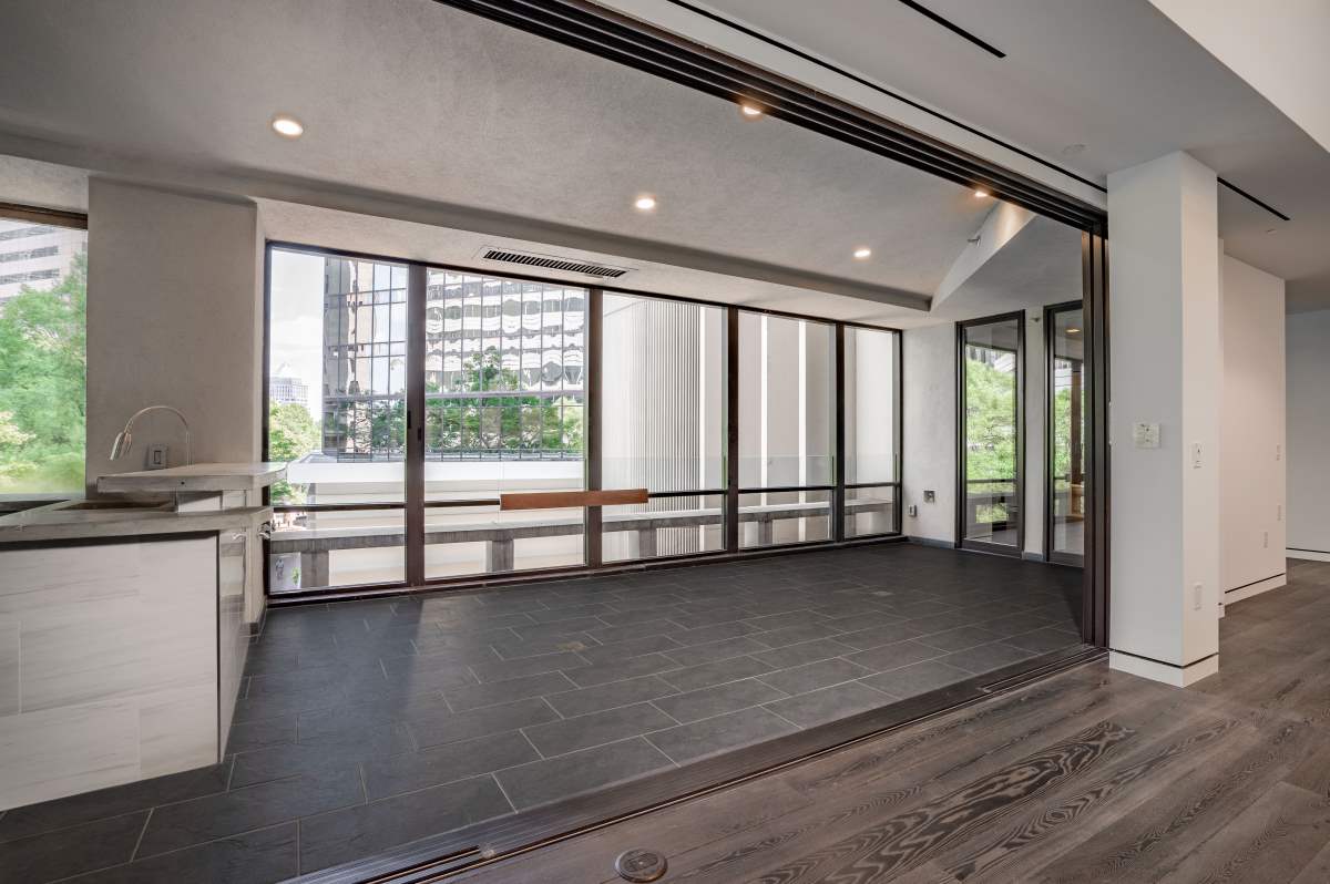 A room with glass walls and wood floors.