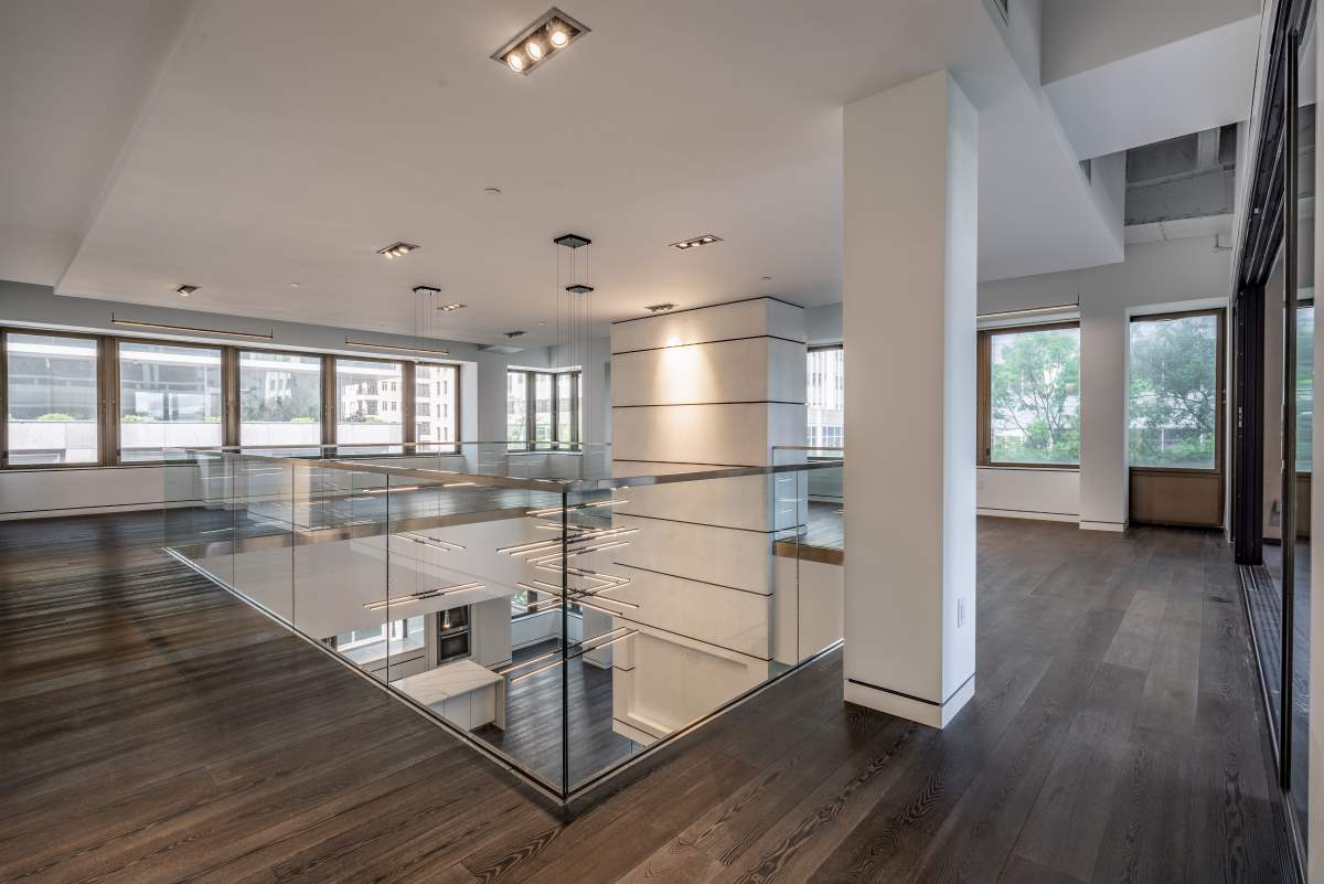 A room with glass walls and wooden floors.