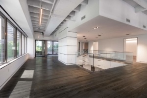 A large room with wooden floors and white walls.