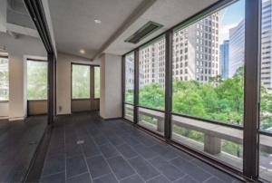 A room with large windows and a view of the city.