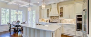 A kitchen with white cabinets and island in it