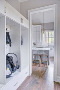 A white room with a lot of cabinets and chairs
