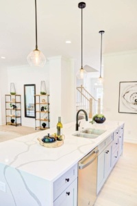 A kitchen with white cabinets and a sink.
