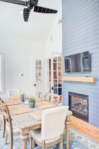 A dining room table with chairs and a fireplace.