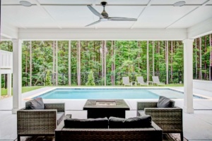 A pool with a view of the trees and the woods.