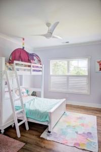 A bedroom with bunk beds and a rug.