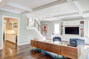 A living room with hardwood floors and a television.