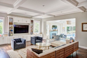 A living room with couches, chairs and a television.