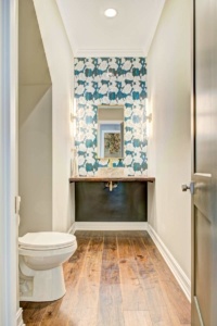 A bathroom with wood floors and a toilet.