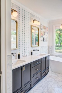 A bathroom with two sinks and mirrors in it