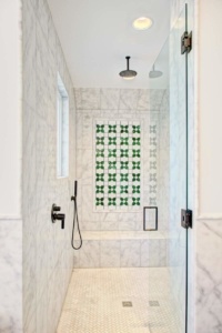 A bathroom with a shower and tiled walls.