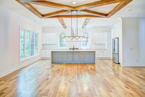 A large kitchen with wooden floors and white walls.