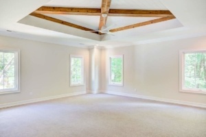 A room with two windows and a ceiling.