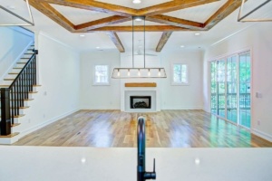 A room with wood floors and beams in it