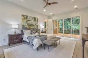 A bedroom with a large bed and two benches.