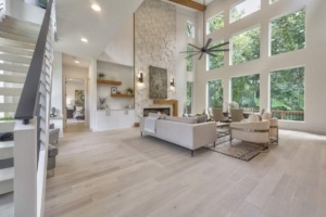 A living room with lots of windows and furniture.