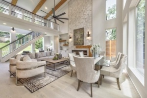 A living room with a fireplace and a dining table.