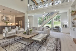 A living room with stairs and a large window.
