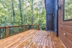 A wooden deck with trees in the background