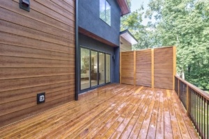 A wooden deck with a sliding glass door.