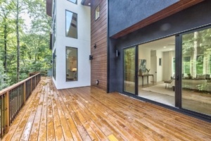 A large wooden deck with sliding glass doors.