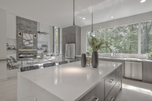 A kitchen with a large island and white cabinets.