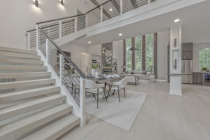 A large open living room with stairs leading to the second floor.