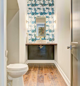 A bathroom with wood floors and a toilet.