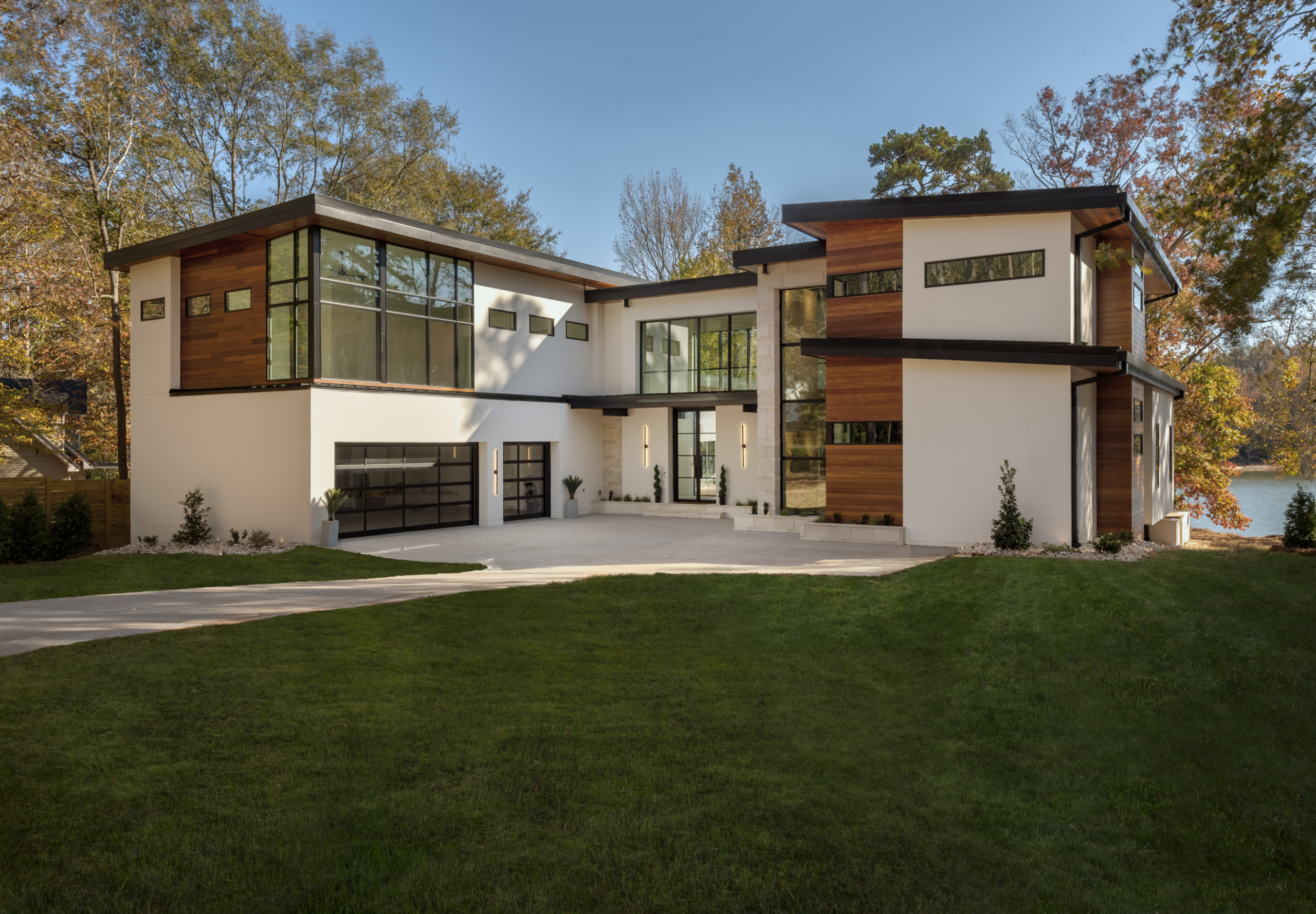 A large modern house with grass in front of it.