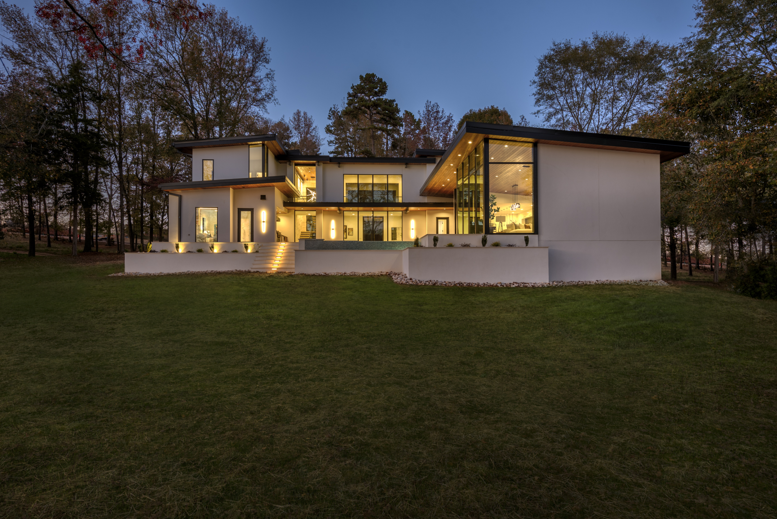 A large white house with lights on the outside.