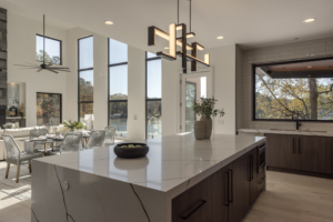 A large kitchen with a center island and a dining room table.