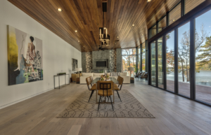 A dining room with wood floors and a fireplace.
